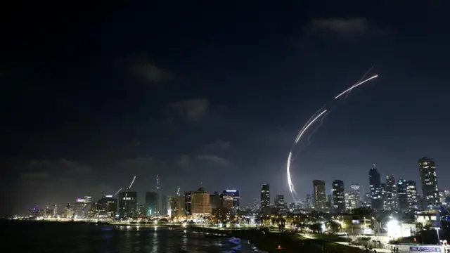 A string of bright lights amidst buildings in Tel Aviv