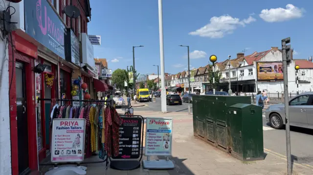 A street with shops selling clothes in Wembley.