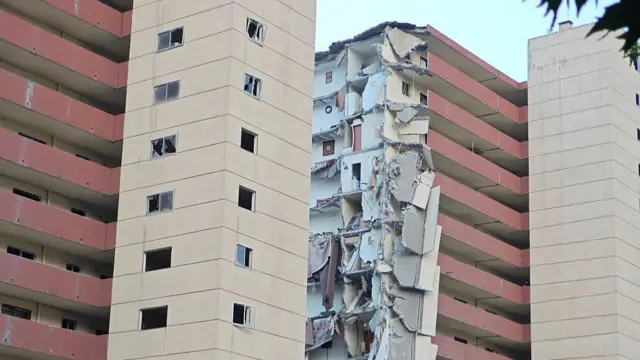Wide shot of a damaged pink building