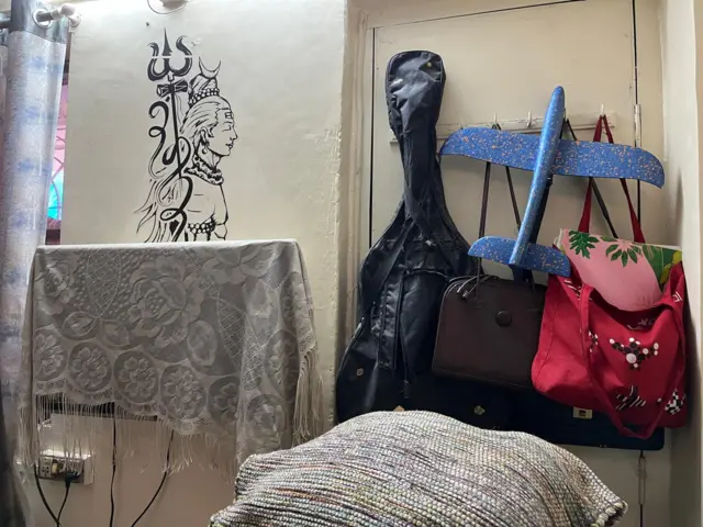 A plastic aeroplane model hangs behind the door, a reminder of Saineeta's passion for flying