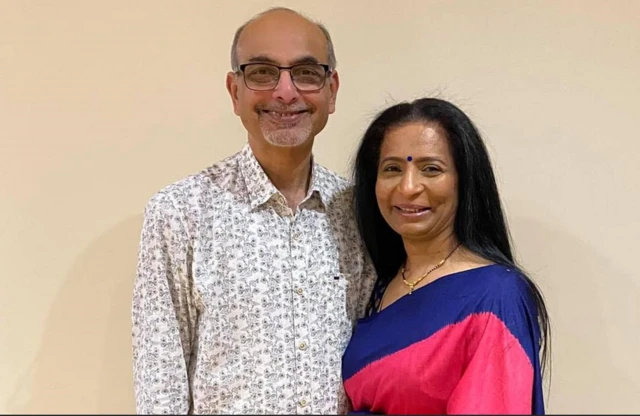Two people are pictured close to each other, smiling