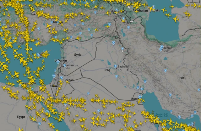 a map of the middle east shows empty skies over most of the region. small planes marked in yellow can be seen travelling around the area but not through it