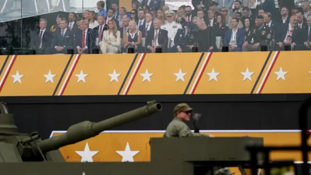Donald Trump watches soldiers march past