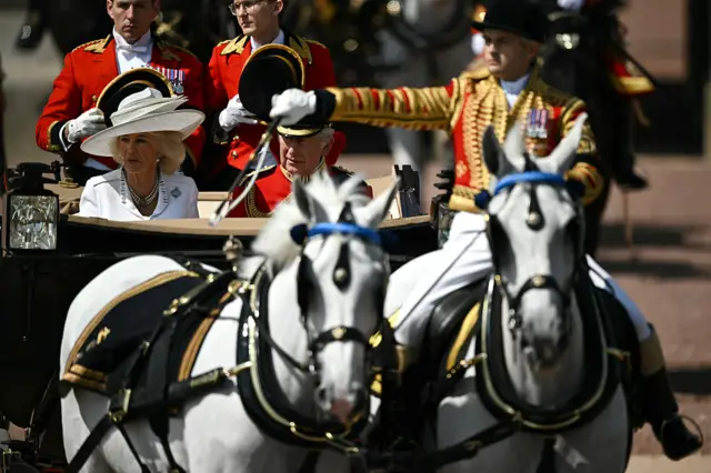 Britain's King Charles III and Britain's Queen Camilla make their way from Buckingham Palace to Horse Guards Parade in a open carriage.
