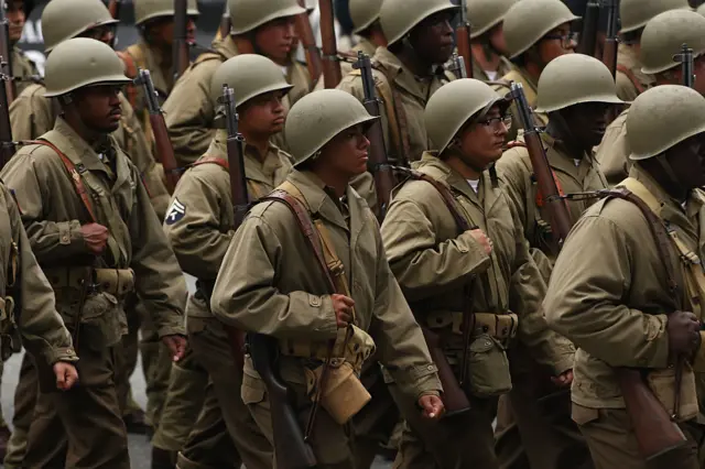 Soldiers dressed in World War II uniforms march in the military parade