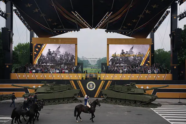 US President Donald Trump and guests watch as members of the US Army parade down Constitution Avenue