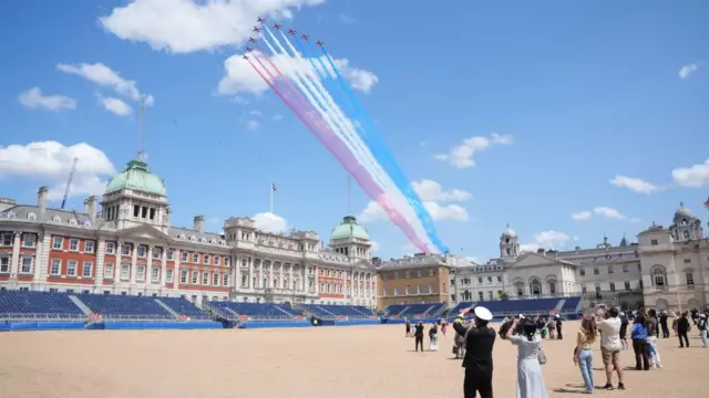 The Red Arrows take part in a flypast, seen from Horse Guards Parade.