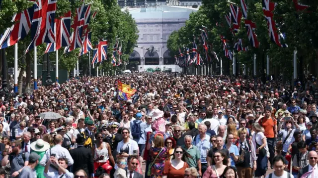 Thousands of people walk along the Mall.