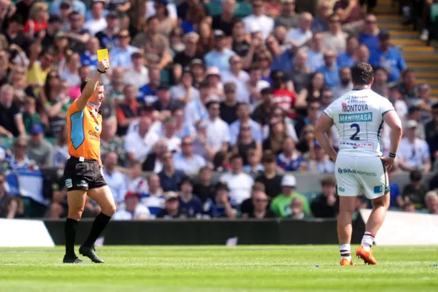 Julian Montoya is shown a yellow card