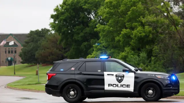 A police SUV in front of some trees