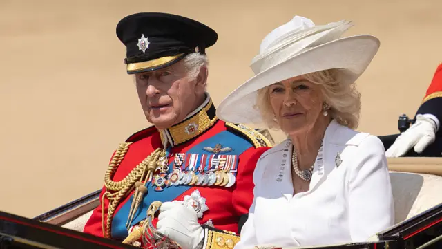 Charles and Camilla sit in the carriage.