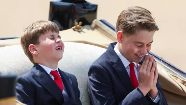 Prince George reacts as he rides a carriage with Prince Louis, Catherine, Princess of Wales, and Princess Charlotte (not pictured) as part of the Trooping the Colour parade which honours Britain's King Charles on his official birthday