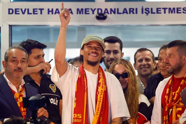 Leroy Sane with a Galatasaray scarf around his neck
