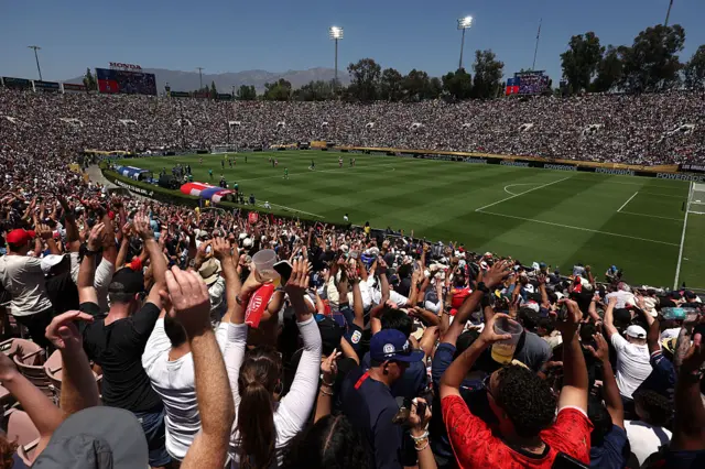 Fans do a mexican wave in the stands