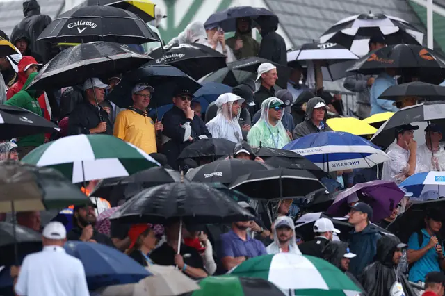 Crowd sheltering under an umbrella