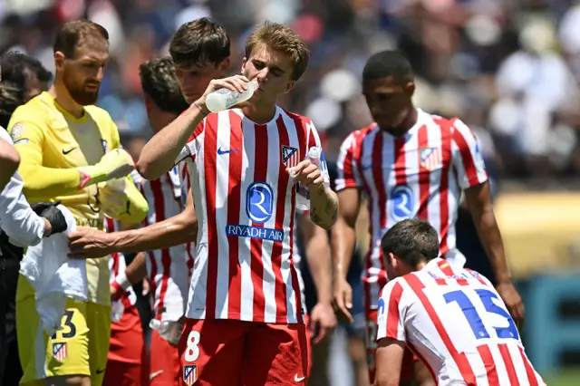 Atletico players take on drinks during a cooling break