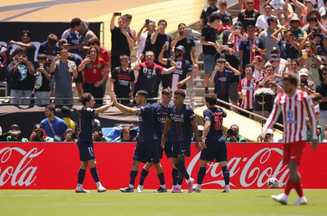 De Paul trudges back to kick off as the PSG players celebrate