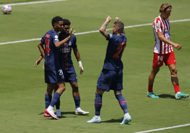 PSG players celebrate their third goal as Atletico players trudge back to kick off