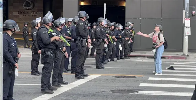 A protester confronts police in LA