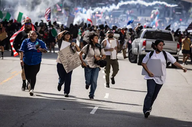 Protesters run after tear gas is deployed