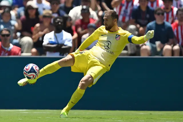 Oblak clears the ball up field with a long kick