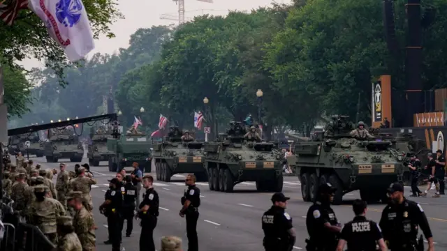 Tanks drive down a street in Washington DC