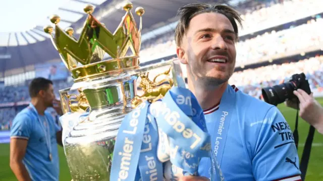 Jack Grealish of Manchester City celebrates with the Premier League trophy