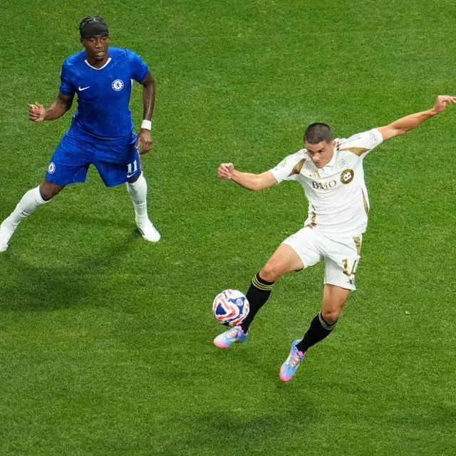 Palencia controls the ball as Madueke lurks nearby
