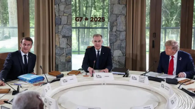French President Emmanuel Macron, Canadian Prime Minister Mark Carney and US President Donald Trump sit round the G7 summit table.