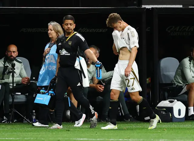 Ordaz wipes his face with his shirt as he walks off the pitch