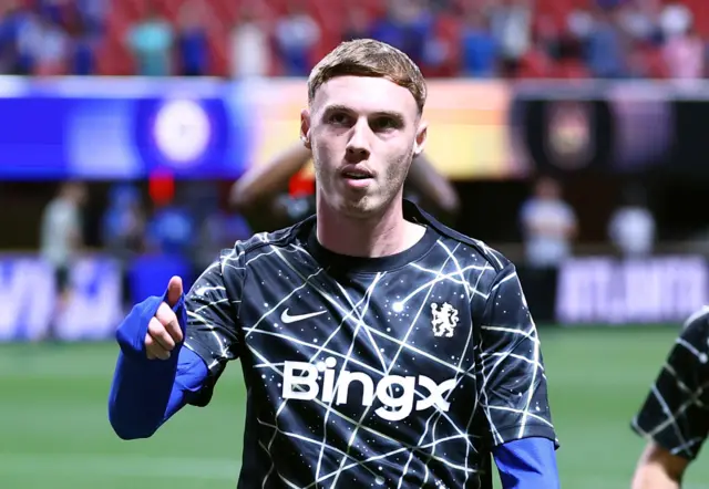 Cole Palmer gives a thumbs up to the fans