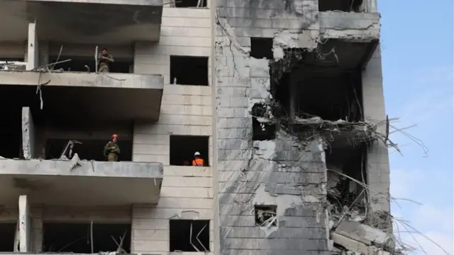 A gaping hole in a concrete high rise building
