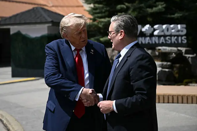 US President Donald Trump (L) shakes hands with British Prime Minister Keir Starmer as they speak to reporters