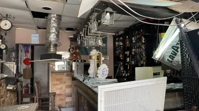 A small bar, damaged by missile strike
