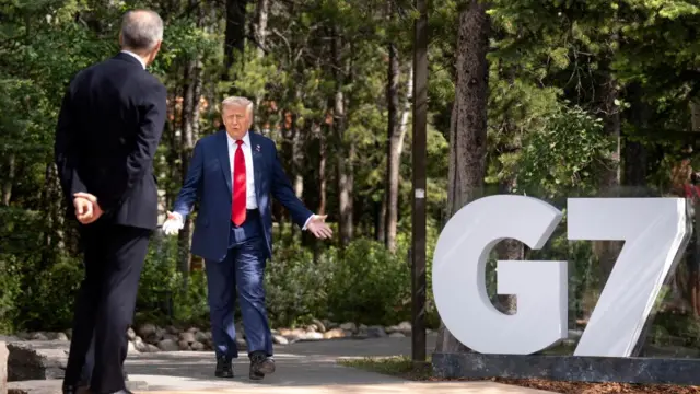 U.S. President Donald Trump is greeted by the Prime Minister of Canada Mark Carney, as he arrives at the G7 leaders' summit