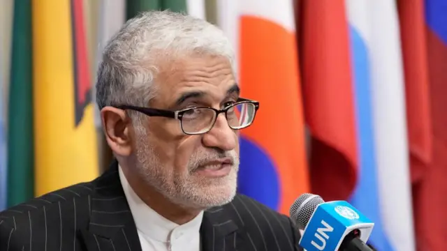 A file photo of Amir Saeid Iravani, he is speaking into a UN microphone with the flags of different countries behind him