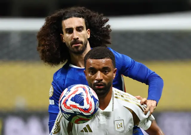 Cucurella tries to win the ball back from an LA player
