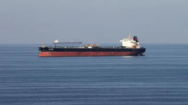 A commercial ship sails on open water.