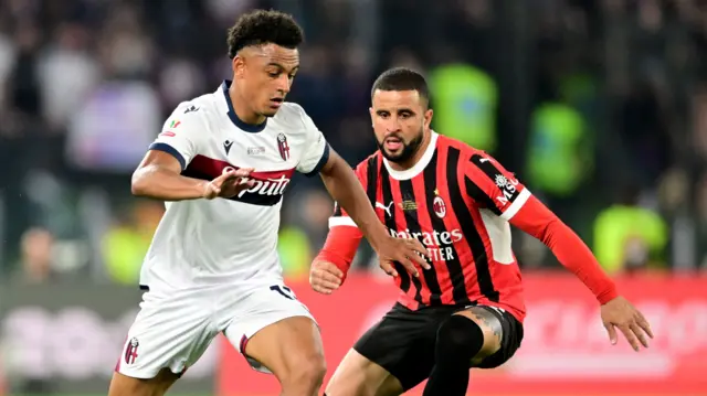 Bologna's Dan Ndoye runs with the ball against AC Milan's Kyle Walker