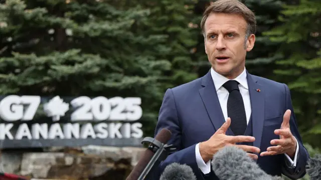 Macron speaking to reporters in Alberta, Canada