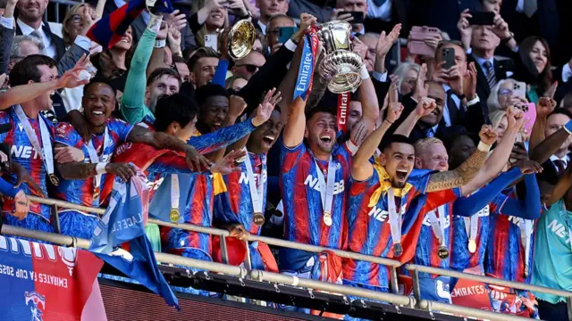Marc Guehi and Joel Ward of Crystal Palace lift the FA Cup trophy