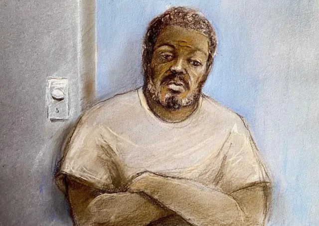 A court artist's sketch of Jazwell Brown. He is wearing a pale T-shirt and has his arms folded.