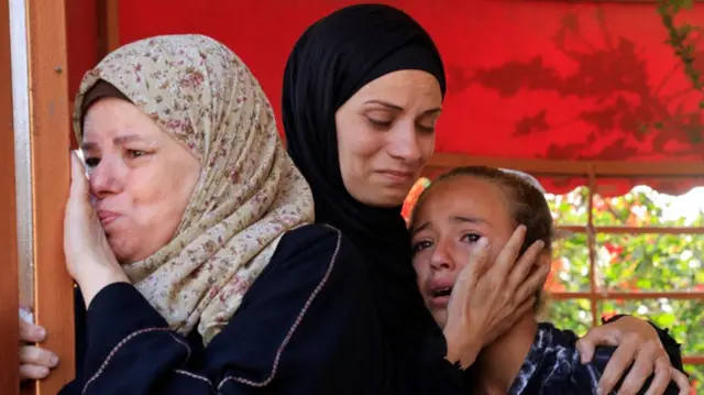 Mourners react during the funeral of Palestinians killed in what the Gaza Health Ministry said were Israeli strikes, in Khan Younis