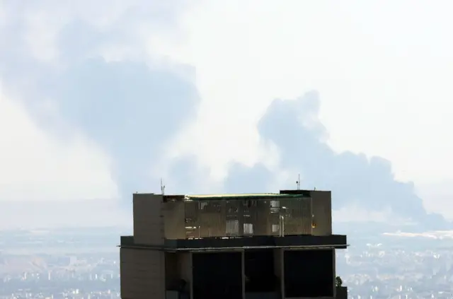 Smoke rising from a city skyline in Tehran