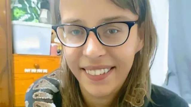 Teohna Grant wearing glasses and smiling.