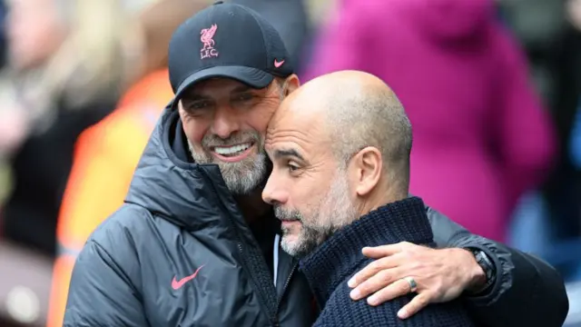 Juergen Klopp, Manager of Liverpool, embraces Pep Guardiola, Manager of Manchester City