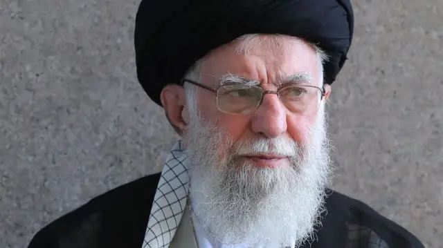 Khamenei in black attire looking to the side
