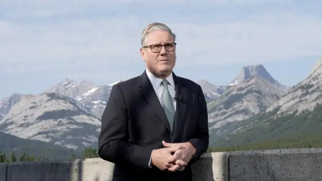 Starmer has his photo taken against a mountain backdrop in Canada