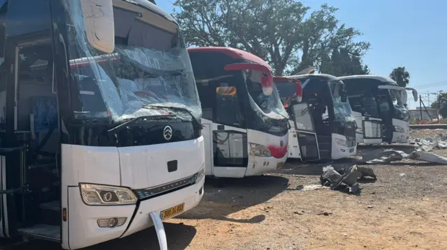 A row of damaged buses