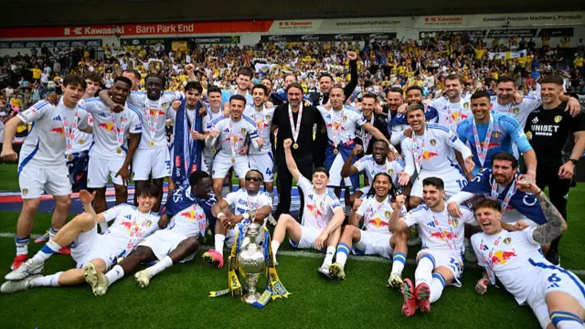 Players of Leeds United pose for a photo with the Sky Bet Championship trophy,